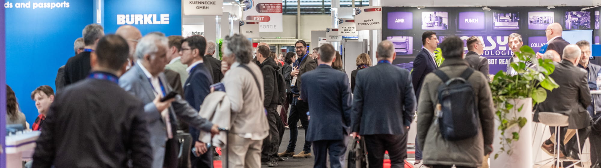 Visitors and exhibitors in the aisles and booths at TRUSTECH