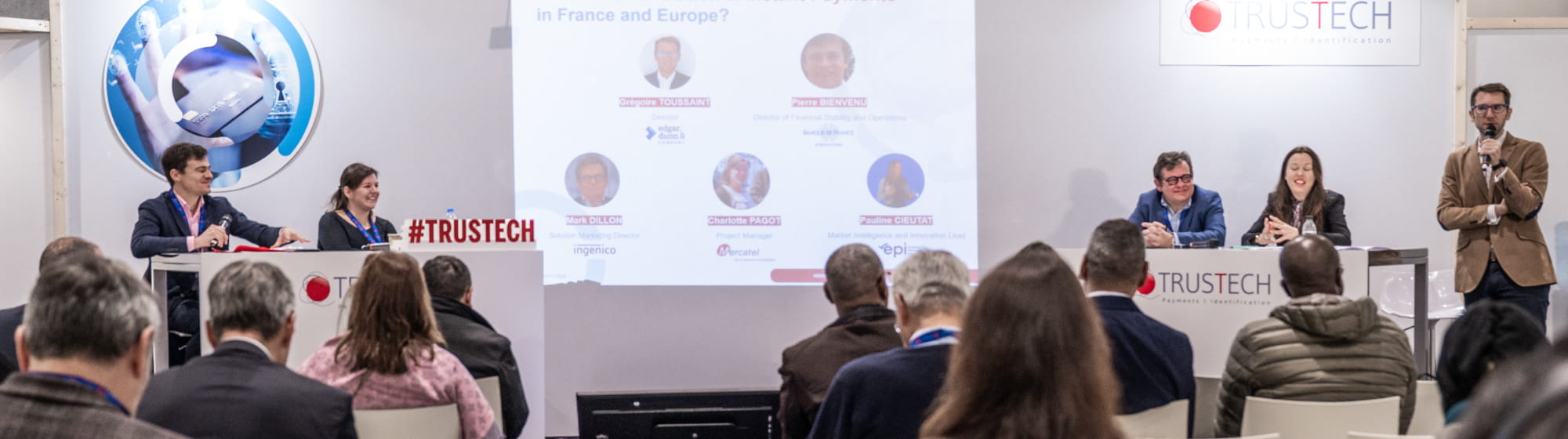 People attending a round table on instant payments featuring 5 speakers in the TRUSTECH conference room