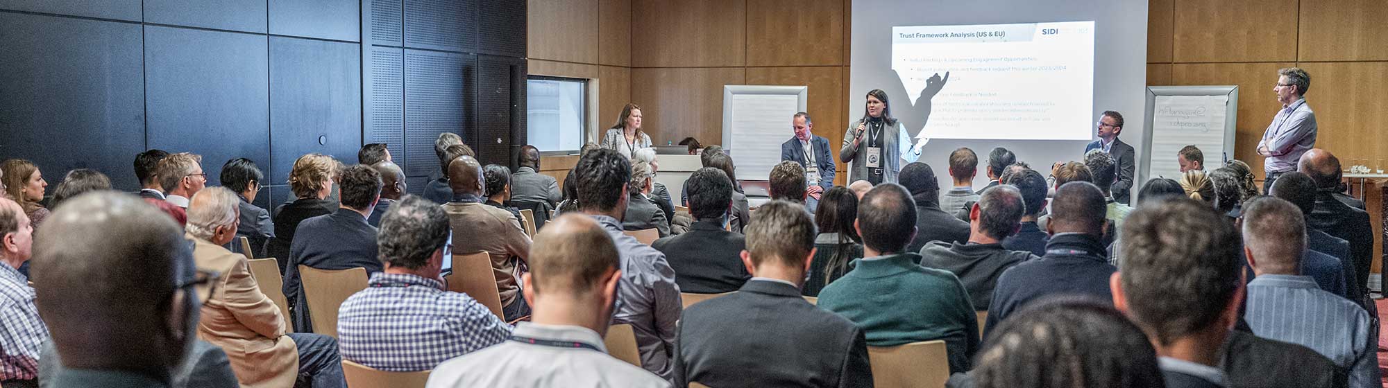 Full conference room, with audience listening to a presentation at the Sidi Hub organised at TRUSTECH 2023