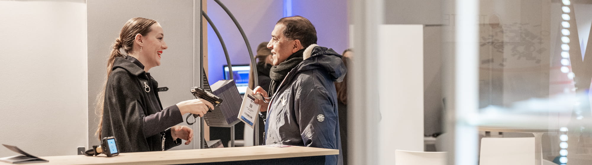 Visitor asking for help to an hostess at the information desk