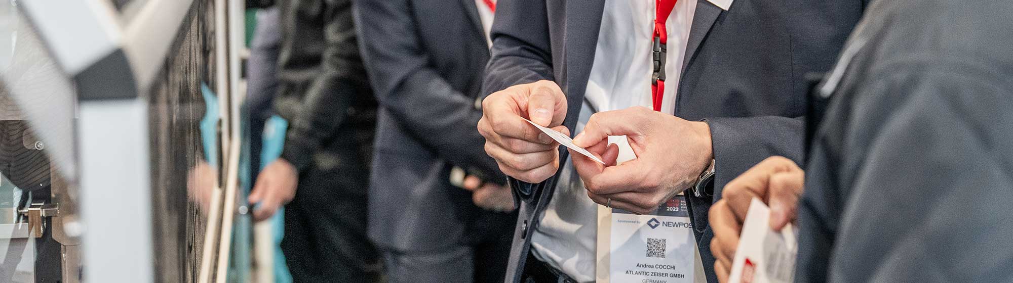 An exhibitor show a cart to a visitor in his booth