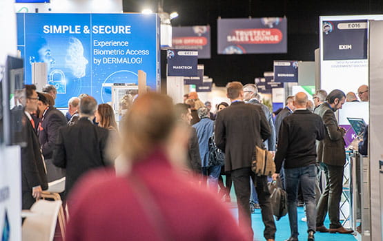 A crowd of visitors walking through the aisle of trustech exhibition