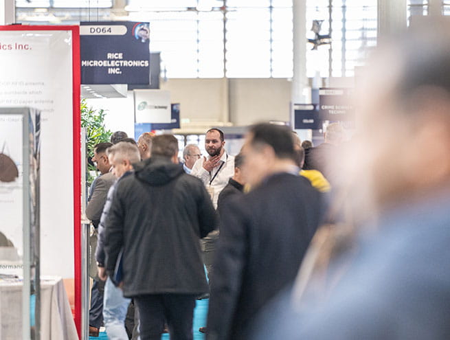 Vistors walking through the aisles of TRUSTECH exhibition