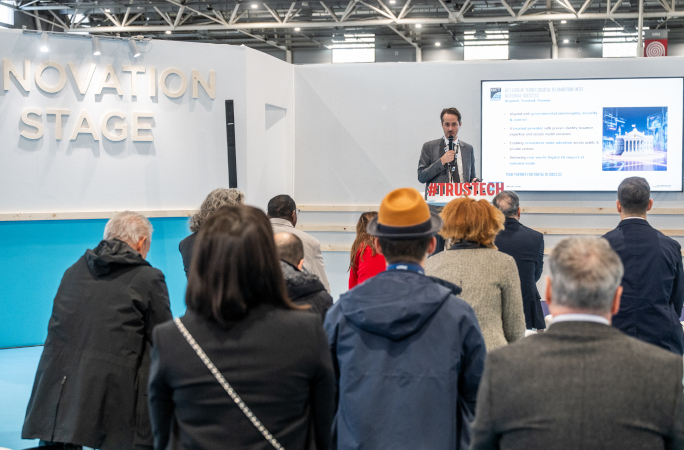 Conference at TRUSTECH 2025 on the Innovation Stage with a speaker presenting to a professional audience