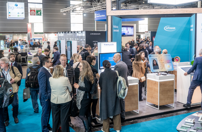 View of TRUSTECH exhibition floor with professionals visiting a booth focused on identity and payment solutions