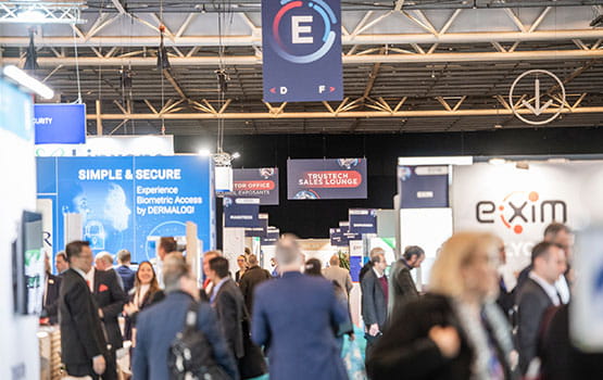 visitors stroll through the aisles of the Trustech exhibition